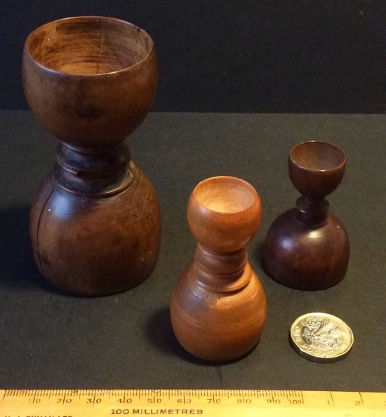 Antique treen apothecary measures.