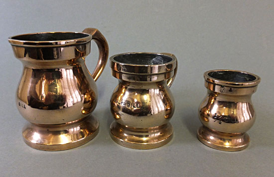 Three brass or bronze gill, 1/2gill, 1/4gill baluster measures.