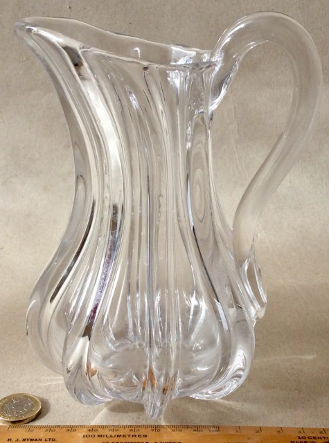 Antique early 19th century clear glass hand blown jug with applied handle.