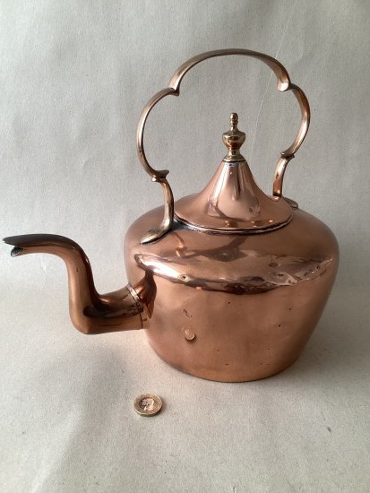 Antique copper kettle with C scroll handle and tent lid.