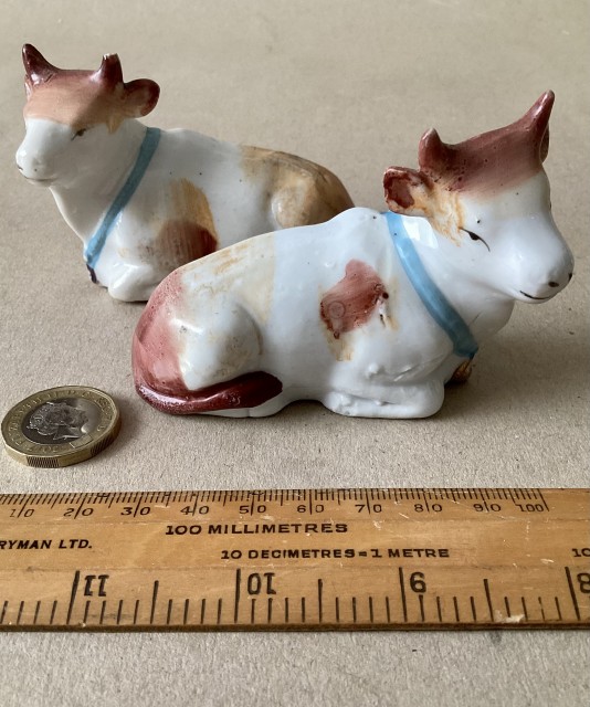 Antique pair of Victorian porcelain cow ornaments. C1890