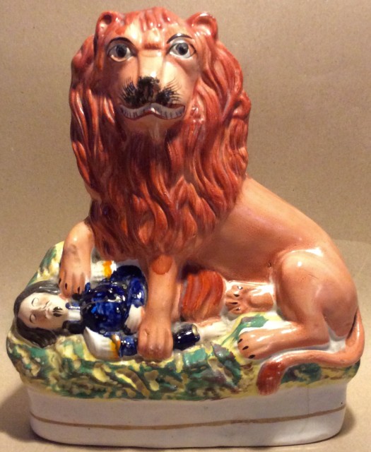 Antique Staffordshire pottery figure. The British lion crushing Napoleon III.