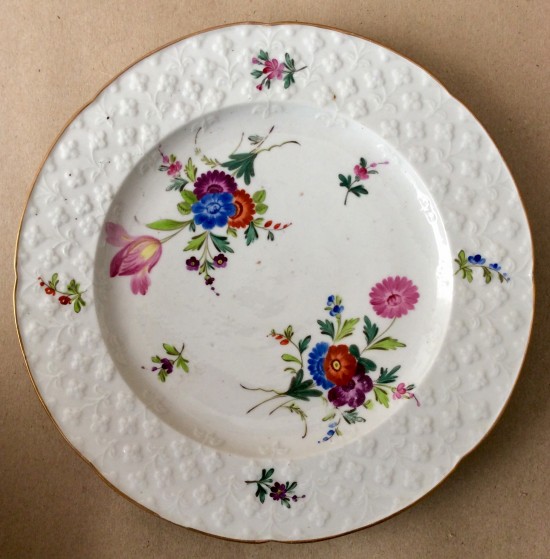 Antique porcelain press moulded German flower plate.