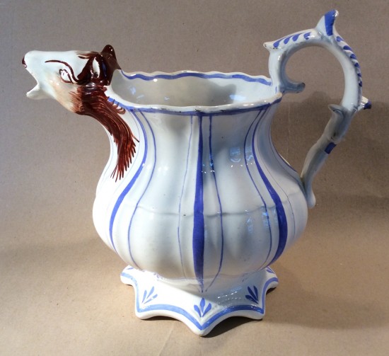 Victorian pottery jug with horse head spout.