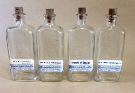 Four mid C20 glass medicine bottles