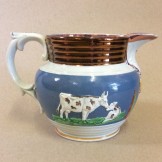 Creamware jug with relief mounded cows and farmer