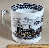 STAFFORDSHIRE COMMEMORATIVE  “TRAIN MUG” c1860 black transfer with added  red and brown.