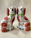 Pair of Staffordshire spaniel dogs with baskets.