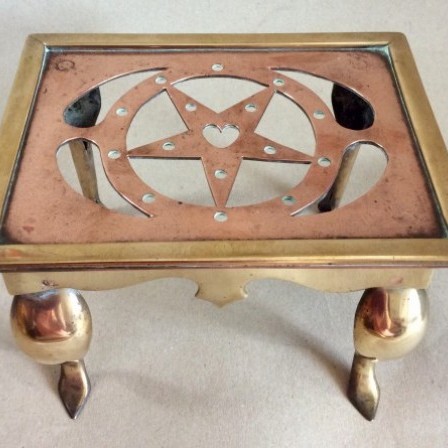 Detail: Small late Victorian/Edwardian pierced copper and brass Footman or Trivet.