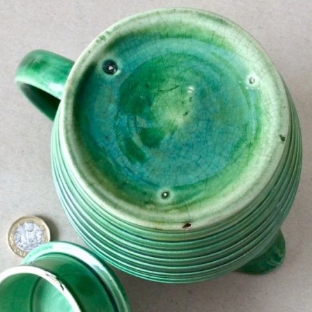 Detail: Antique green glazed ribbed pottery coffee pot