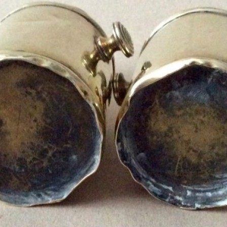 Detail: Pair of antique brass churn shaped tea caddies or cream carriers.
