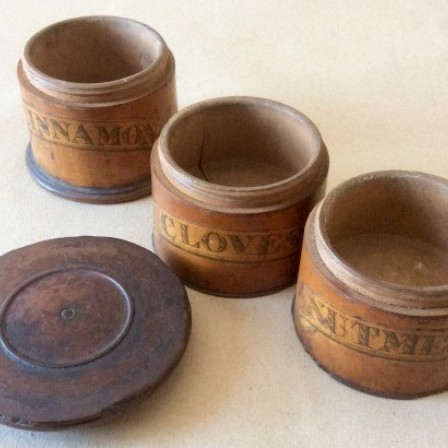 Detail: 19th century  sycamore spice turret with paper labels, Cloves, Nutmeg, and Cinnamon.