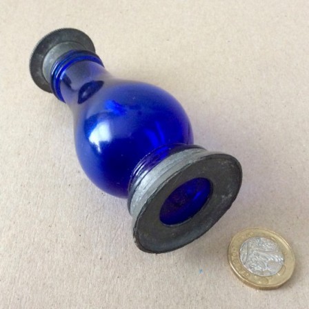 Detail: Antique pewter mounted blue glass pepper pot.
