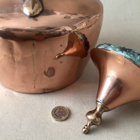 Detail: Antique copper kettle with C scroll handle and tent lid.