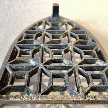 Detail: Antique KENRICK & SONS No. 11 heavy cast brass iron stand/trivet.