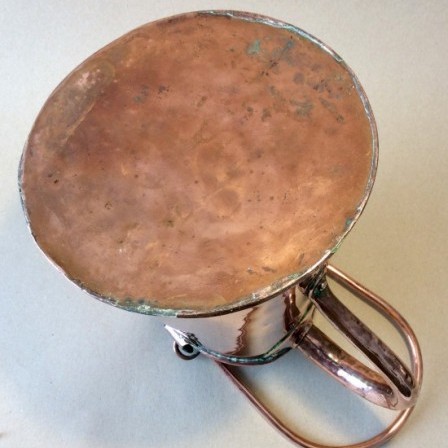 Detail: Antique 19th century copper ale jug with copper bail  carrying handle.