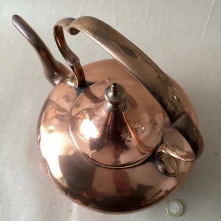 Detail: Antique copper kettle with C scroll handle and tent lid.