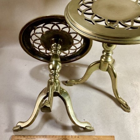 Detail: Victorian heavy brass tripod table high trivets with round pierced tops.