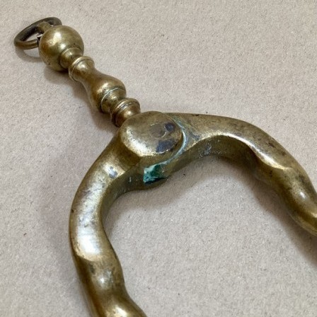 Detail: Antique Dutch spiral brass fire tongs. 