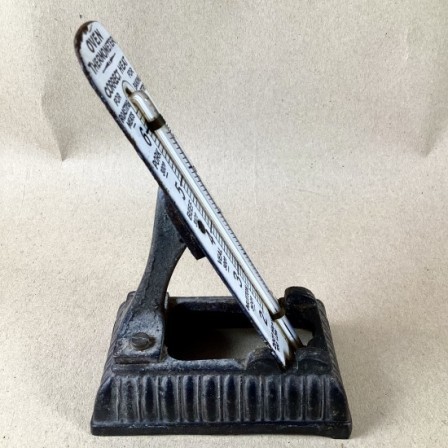 Detail: Antique cast iron and enamel kitchen thermometer