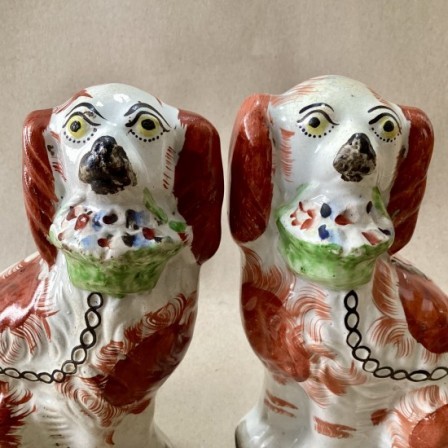 Detail: Antique pr. of Staffordshire spaniels with baskets.